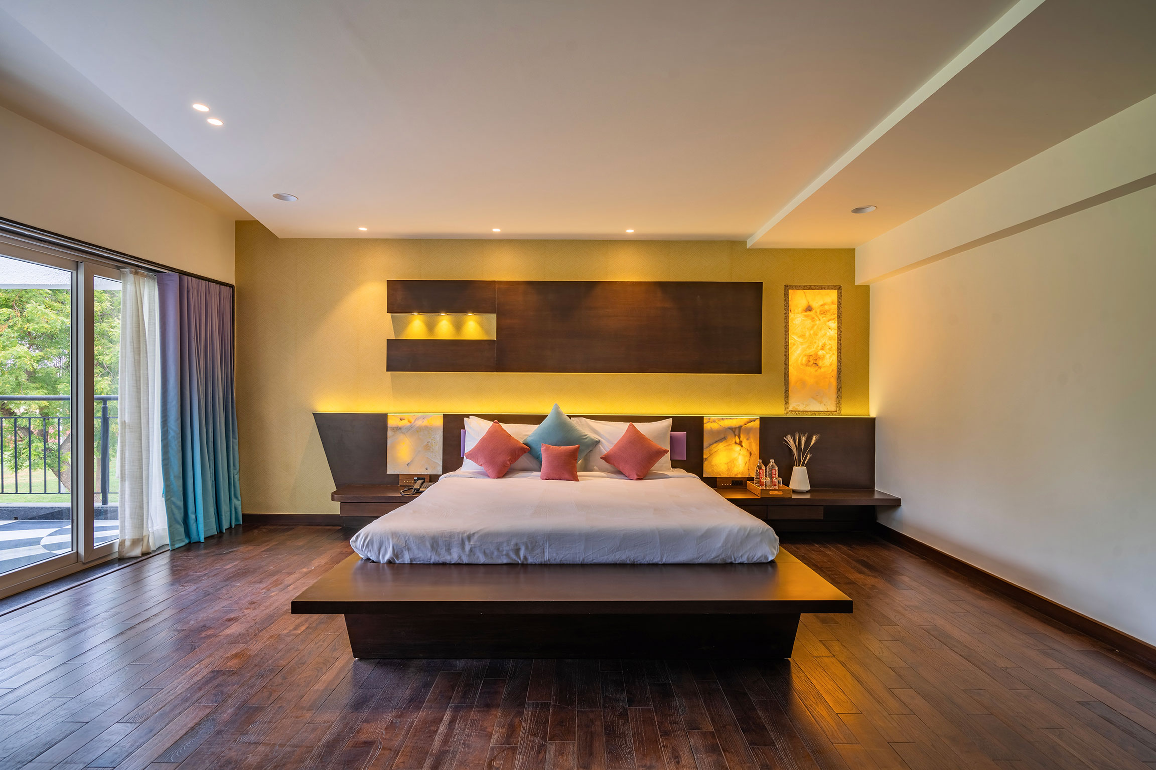 Family Suite bedroom with private balcony at Roadies Rostel ARC Resort Ahmedabad