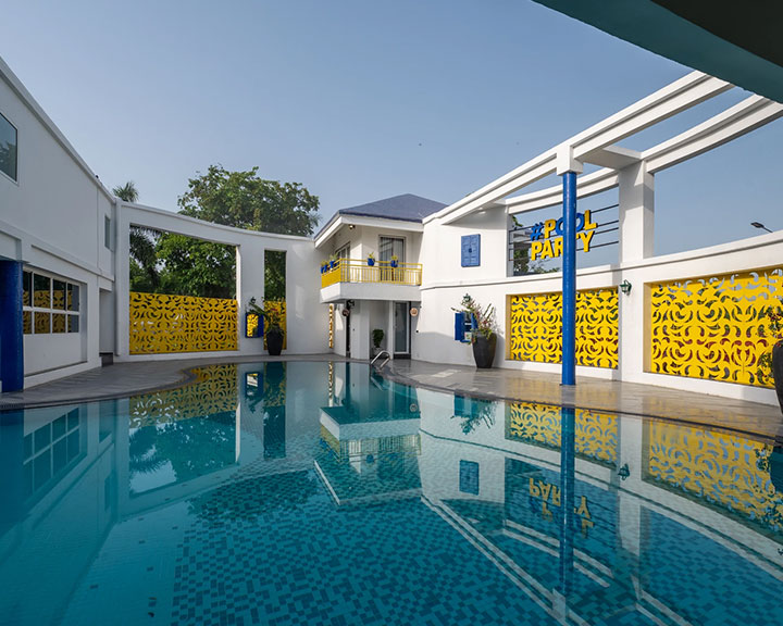 Guests enjoying a relaxed swim at Roadies Rostel ARC, the best resort in Ahmedabad for staycations