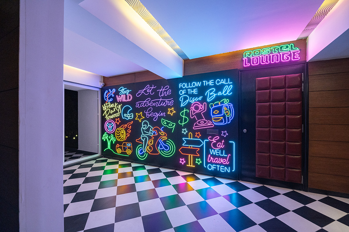 Neon-lit discotheque lounge with vibrant wall art at Roadies Rostel ARC Resort, ideal for nightlife and party lovers