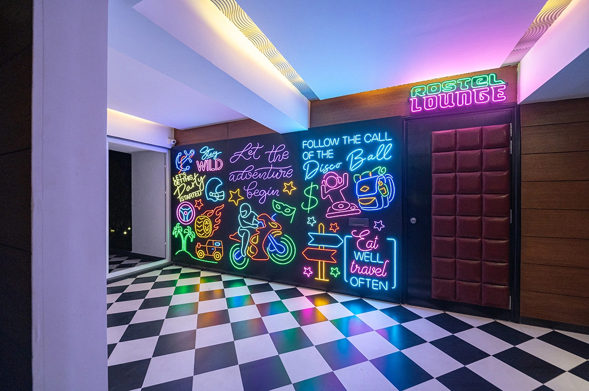 Neon-lit discotheque lounge with vibrant wall art at Roadies Rostel ARC Resort, ideal for nightlife and party lovers